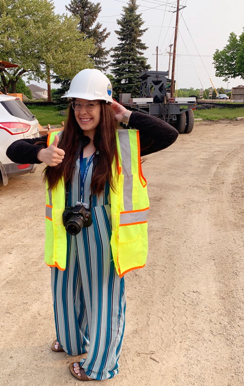 Student in hard hat with a camera.