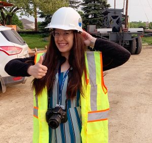 Student in hard hat with a camera.