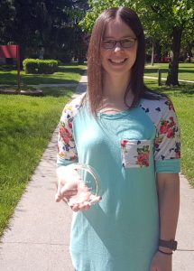 Photo of an individual holding an award.