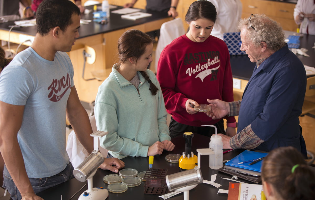 Photo of professor and three students in a lab