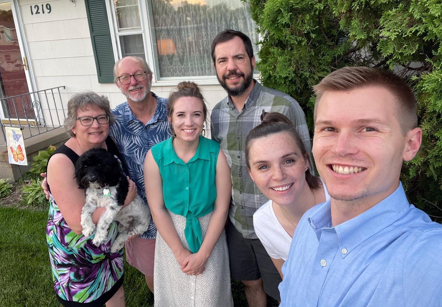 Family photo: Picture, from left, Deb, who is holding Jude, and Dr. Byron Jensen, Hannah ‘15 and Rev. Damen Jensen-Heitmann, Anna Griggs ‘17 and Nathan Jensen ‘18.