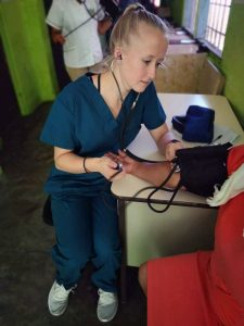 Camilla Lee taking blood pressure of patient