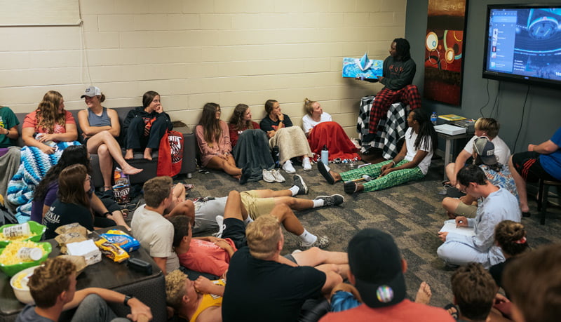 Students having a story read to them.