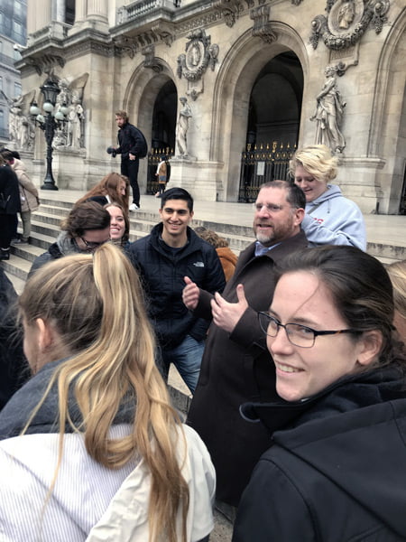 Students on the steps of an opera house in Paris.