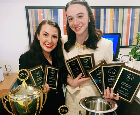 Photo of Alli Kennon and Carly Spotts-Falzone with trophies.