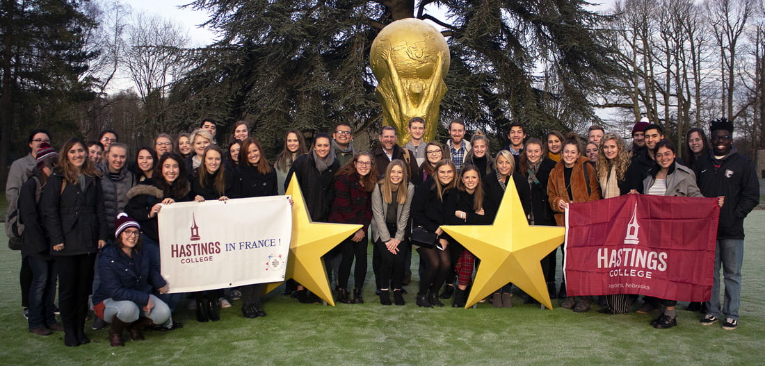 Students lined up for a photo outside a soccer complex in France.