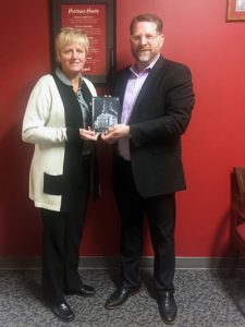 News 9 Photo of two individuals with an award.