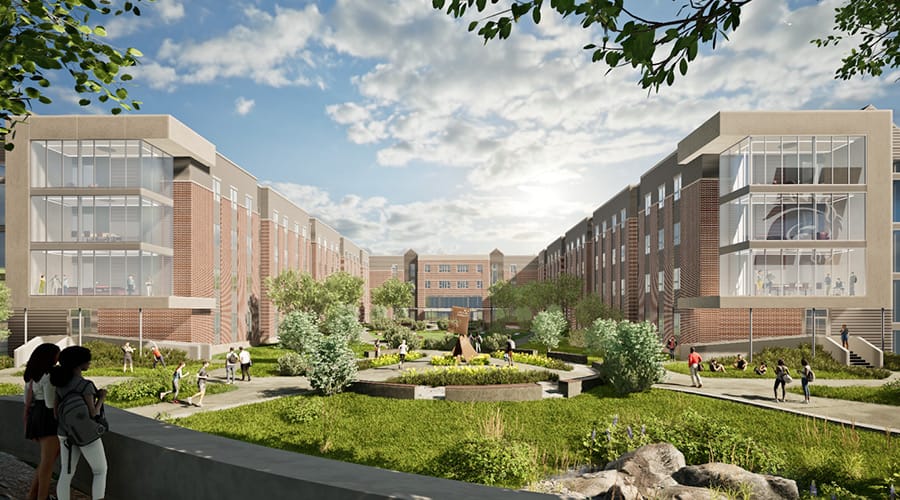 Home 1 Photo of the courtyard of a new residence hall, the 1882. Brick and glass structure, with grass and trees in the courtyard.
