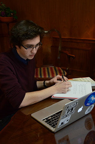Student Brian Whetsone sitting at a desk studying.