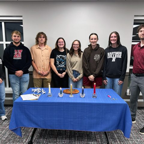 (from left) Current Alpha Chi Vice President Teyla Huff, new members Cooper Ewoldt, Joel Carter, Jamie Wechsler, Lexi Benson, Ann Bose, Lydia Robertson and current Alpha Chi President Levi West.