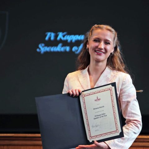 Narick with her Pi Kappa Delta Speaker of the Year award in spring 2025.