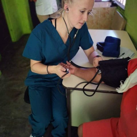 Camilla Lee taking blood pressure of patient