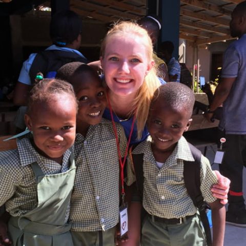 Emma Johnson with children in Haiti