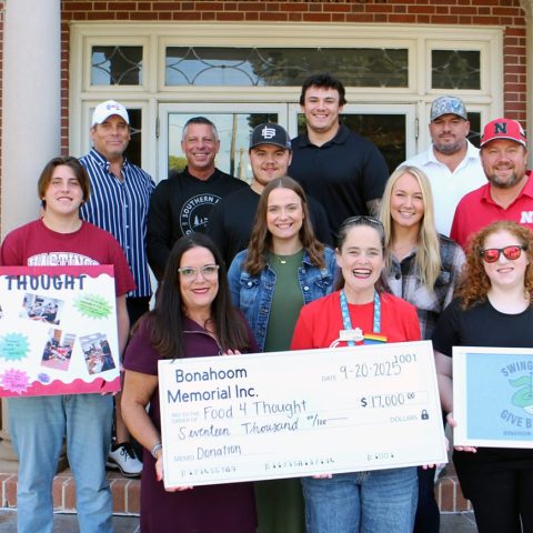 Front row (from left): Sarah Bonahoom-Herbolsheimer; Rev. Doodle Harris, Hastings College chaplain; Maddie Kamler, Food4Thought student volunteer. Second row: Peyton Wallace, Food4Thought student director; Kali Herbolsheimer; Hope Nienhueser. Third row: Owen Herbolsheimer; Jason Herbolsheimer. Fourth row: Hastings Mayor Jay Becky; Scott Voightmann, general manager of Southern Hills Golf Club; Kohl Herbolsheimer; Tyson Bonahoom.