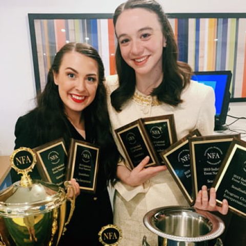 Photo of Alli Kennon and Carly Spotts-Falzone with trophies.