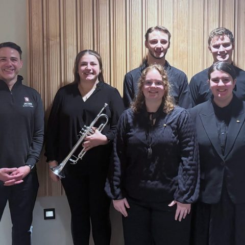Hastings College students at the Nebraska Intercollegiate Band with the guest clinician, Dr. Donald McKinney (on left). Students include (front) Maggie deFreese and Mekenzie Miller, and (back) Krista Hatchell, Dylan Shaw and David Udlock.