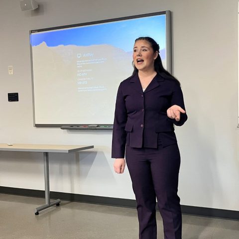 Madi Holman giving her Academic Showcase presentation on AI and literacy rates.