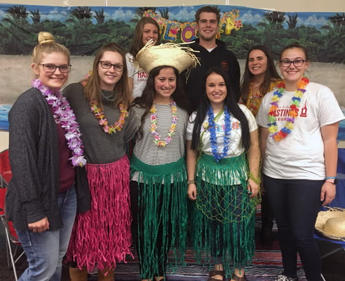 Picture of several college students in luau apparel. 