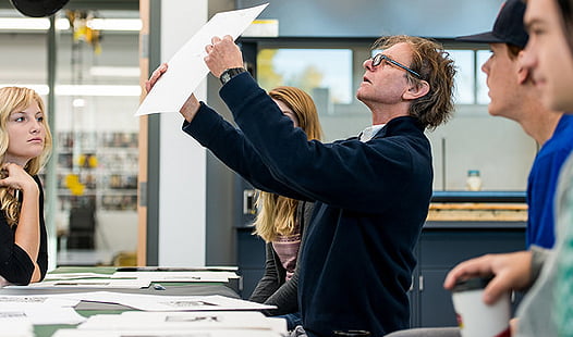 Photo of Turner McGehee inspecting a print.