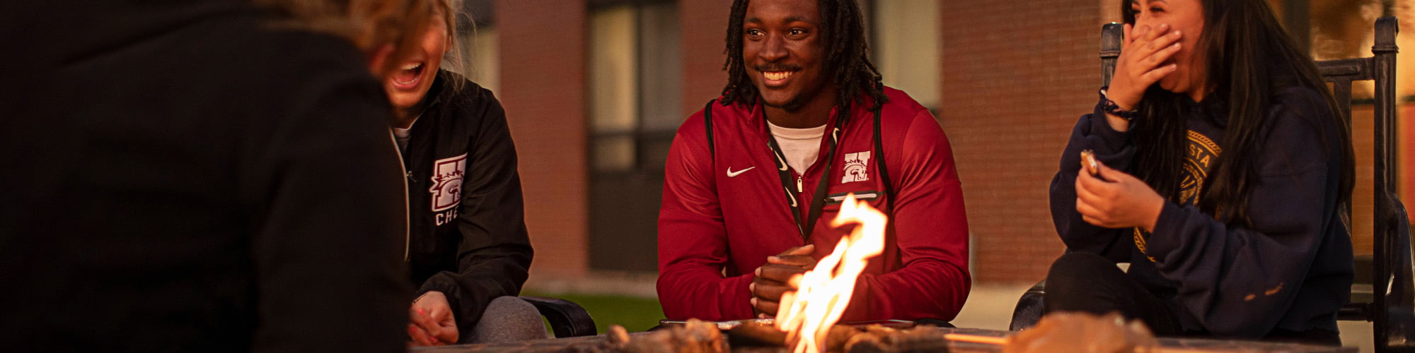 Hastings College students gathered around a fire pit.